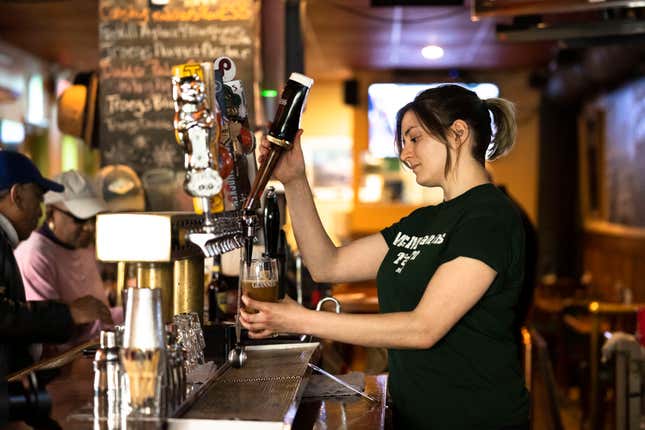FILE - A bartender pours a beer at McMenamin's Tavern in Philadelphia, Thursday, Feb. 9, 2023. Despite having great soft skills, workers with a history of food service work may be overlooked as not having relevant experience when it comes to other careers. These workers, however, often have transferable skills that make for excellent employees, particularly in the fast-paced tech environment.(AP Photo/Matt Rourke, File)