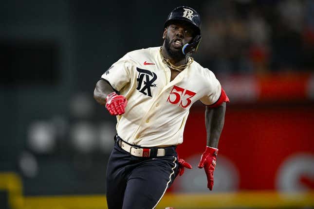 Adolis Garcia of the Texas Rangers fields a ball during the first