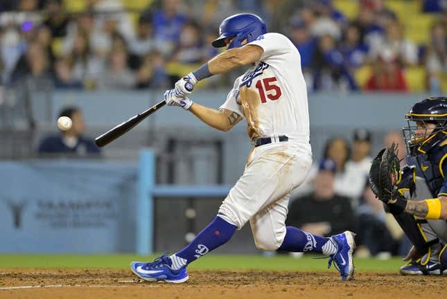 Aug 17, 2023; Los Angeles, California, USA;  Los Angeles Dodgers catcher Austin Barnes (15) hits a solo home run in the eighth inning against the Milwaukee Brewers at Dodger Stadium.