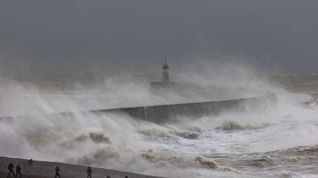 Huge waves batter the coast of England. 