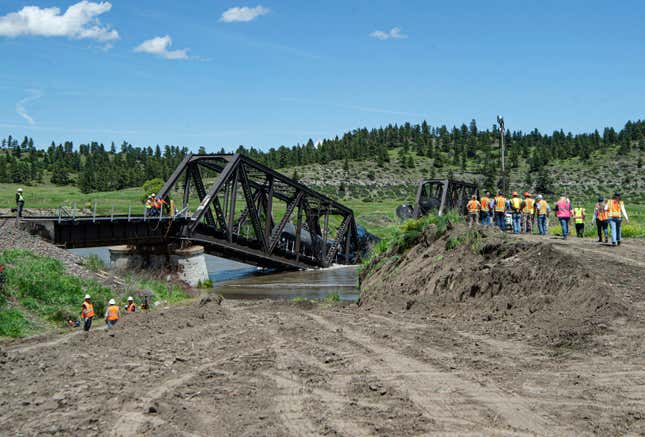Crews work the site of a railroad bridge collapse on the Yellowstone River near Reed Point, Sunday afternoon, June 25, 2023, in Columbus, Montana.