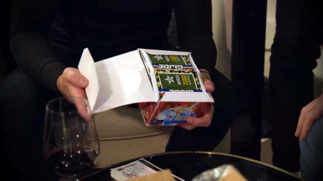 Hands hold a box of G.I. Joe cards that celebrity Logan Paul bought for way too much money. 