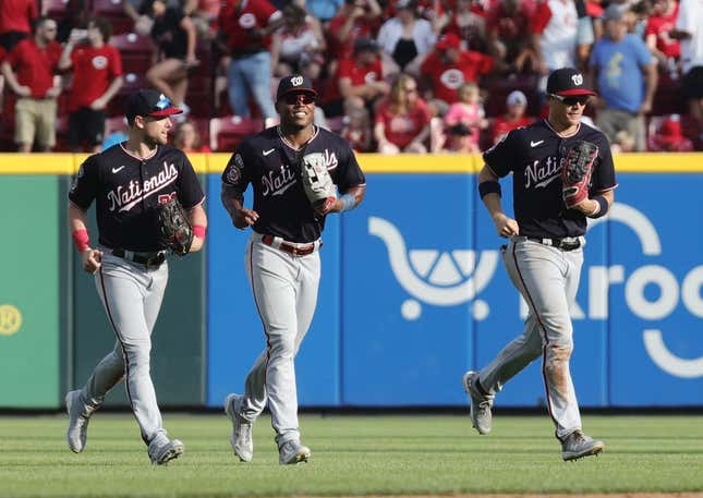 Aug 5, 2023; Cincinnati, Ohio, USA; Washington Nationals outfielders Lane Thomas (left) Stone Garrett (middle) and  Alex Call (right) run off the field after the Nationals defeated the Cincinnati Reds at Great American Ball Park.