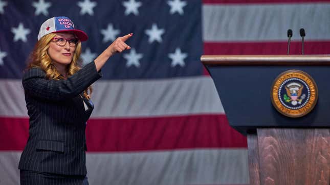 Meryl Streep in front of the US Flag in a hat that says "dont look up"