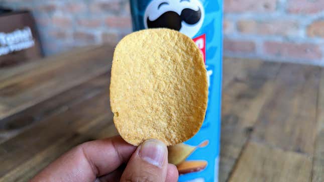 hand holding Pringles Harvest Blends Sea Salt potato chip