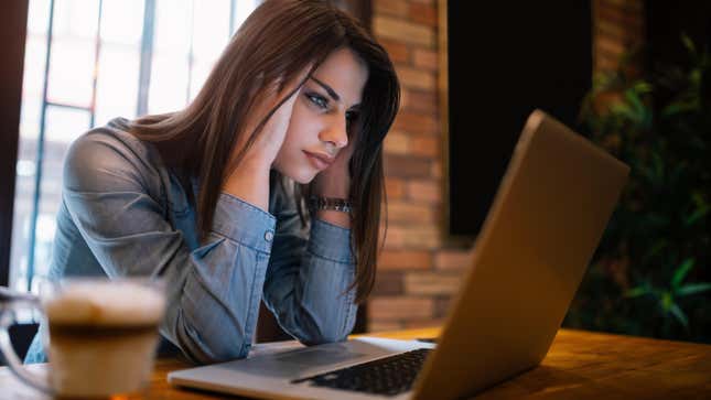 stressed woman looking at laptop screen