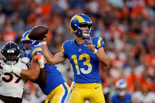 Aug 26, 2023; Denver, Colorado, USA; Los Angeles Rams quarterback Stetson Bennett (13) looks to pass in the first quarter against the Denver Broncos at Empower Field at Mile High.