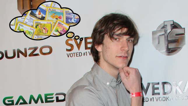 Hugh Hefner’s son Marston poses at an E3 2021 red carpet launch party in Los Angeles, with a thought bubble full of Pokémon cards floating above his head.