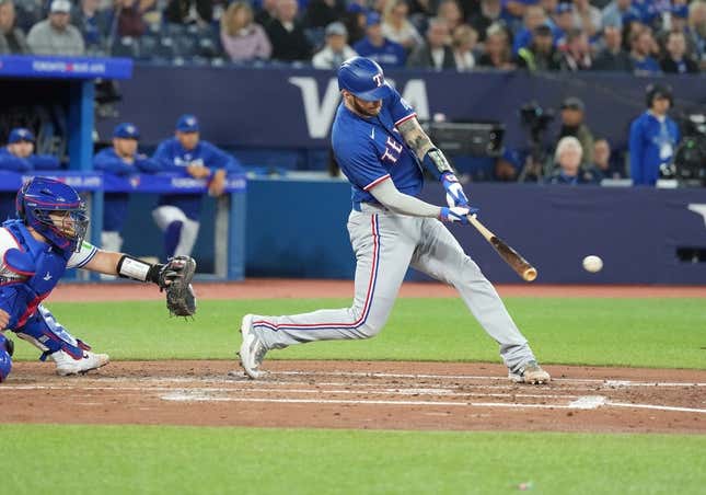 Sep 13, 2023; Toronto, Ontario, CAN; Texas Rangers catcher Jonah Heim (28) hits an RBI single against the Toronto Blue Jays during the fourth inning at Rogers Centre.
