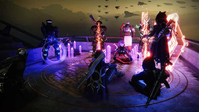 In this Destiny 2 screenshot, several players in the hub world of The Tower emote in front of Titan Commander Zavala.