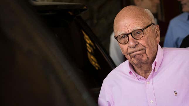 Rupert Murdoch, chairman of News Corp, with a pink collared shirt frowning.