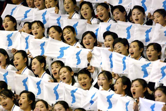 North Korean women hold unified flags at the Daegu Universiade Game in Daegu, South Korea, in 2003.
