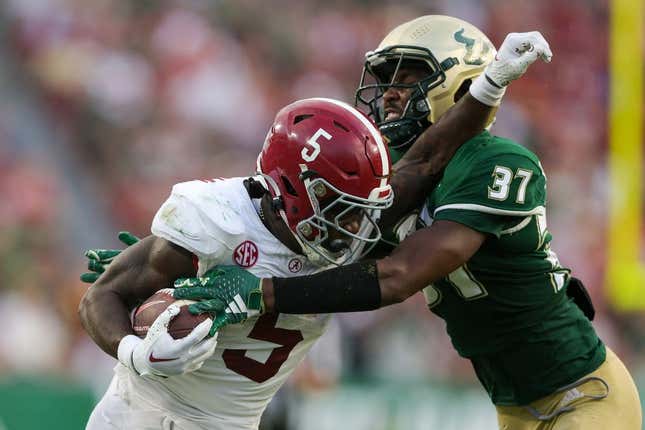 Sep 16, 2023; Tampa, Florida, USA; Alabama Crimson Tide running back Roydell Williams (5) is tackled by South Florida Bulls safety Logan Berryhill (37) in the third quarter at Raymond James Stadium.