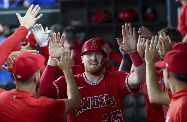 Jun 13, 2023; Arlington, Texas, USA; Los Angeles Angels catcher Chad Wallach (35) celebrates with teammates after scoring during the third inning against the Texas Rangers at Globe Life Field.