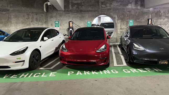 Electric plug-in vehicles parked in designated spaces at a parking garage, California, June 7, 2023.