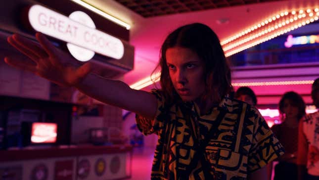 Stranger Things star Millie Bobby Brown uses her powers as Eleven by holding her hand out in front of her.