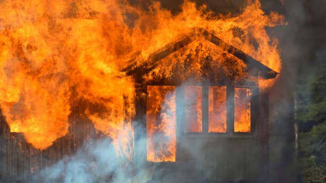 A one-story house is engulfed in flames