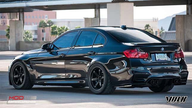 A black F80 BMW M3 is parked and is fitted with Volk TE37 wheels