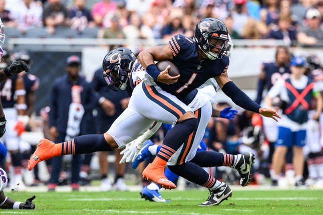Aug 26, 2023; Chicago, Illinois, USA; Chicago Bears quarterback Justin Fields (1) runs the ball against the Buffalo Bills during the first quarter at Soldier Field.
