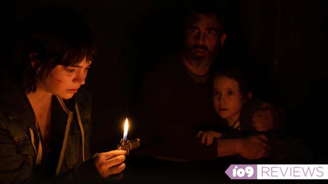 Three people in the dark huddle around a lighter flame