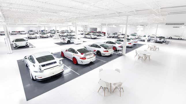 A photo of a room full of white Porsches. 