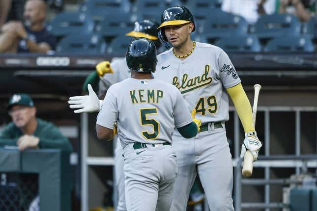 Aug 25, 2023; Chicago, Illinois, USA; Oakland Athletics second baseman Tony Kemp (5) celebrates with first baseman Ryan Noda (49) after scoring against the Chicago White Sox during the second inning at Guaranteed Rate Field.