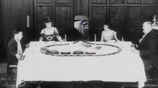 Buster Keaton (far left) and his dinner-table conveyor belt.