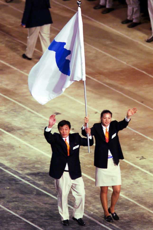 North Korea’s judo coach and a South Korean basketball player carry the unified Korean flag during the opening ceremony of the Olympics in Sydney, Australia.