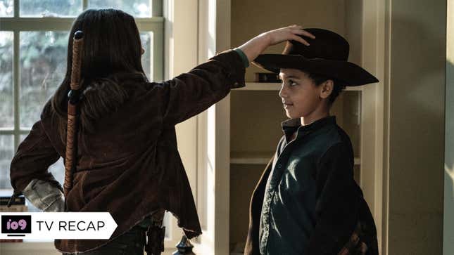 Judith, sword on her pack, places Rick's hat on the head of her little brother RJ.