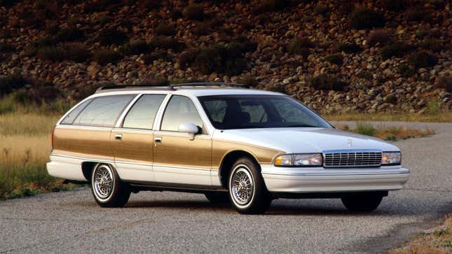 A photo of a white Caprice wagon with panelling down the side. 