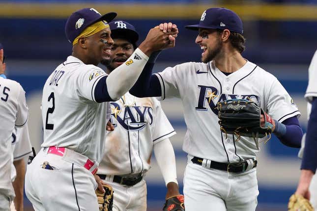 Aug 24, 2023; St. Petersburg, Florida, USA;  Tampa Bay Rays right fielder Josh Lowe (15) and first baseman Yandy Diaz (2) celebrate after beating the Colorado Rockies at Tropicana Field.