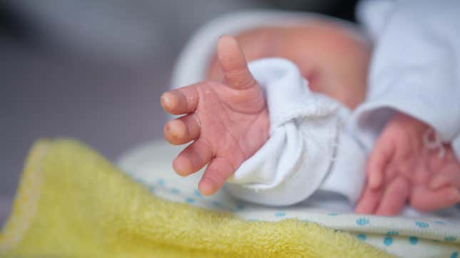 Up close of a newborn baby's hand reaching out