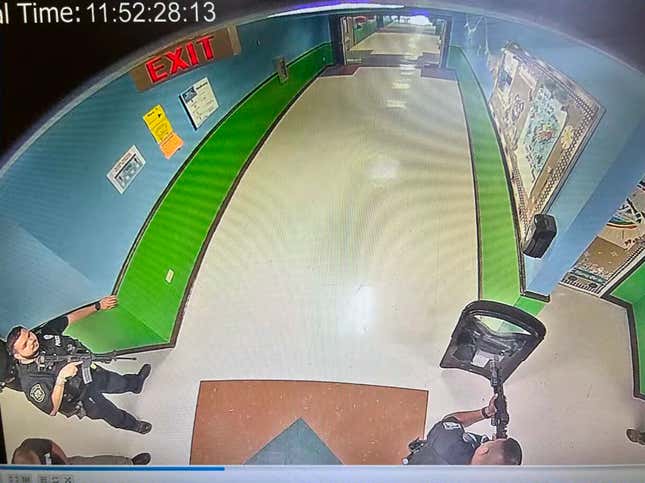 Security camera footage from 11:52 a.m. at Robb Elementary School in Uvalde, Texas on May 24, 2022, where cops with rifles just waited around as kids and teachers were massacred.
