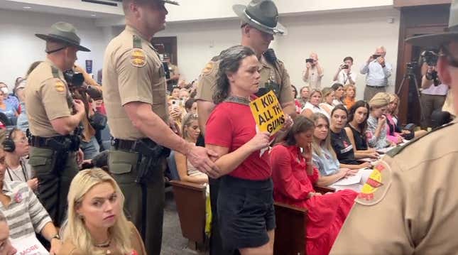 Tennessee state troopers begin to remove gun safety protesters from a meeting of the state legislature.
