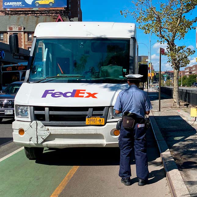 A photo of a delivery van parked in a bike lane. 