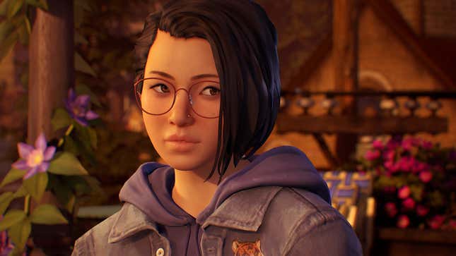 A closeup shot of a woman wearing a jean jacket over a hoodie and round glasses in Life Is Strange: True Colors, one of the best games of 2021