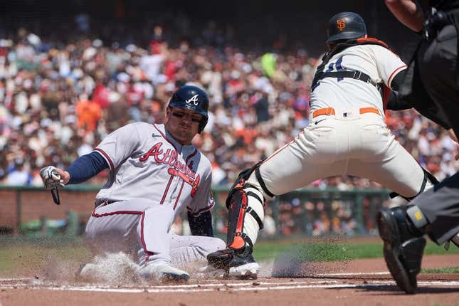 Aug 26, 2023; San Francisco, California, USA; Atlanta Braves infielder Austin Riley (27) slides safely into home against San Francisco Giants catcher Patrick Bailey (14) during the first inning at Oracle Park.