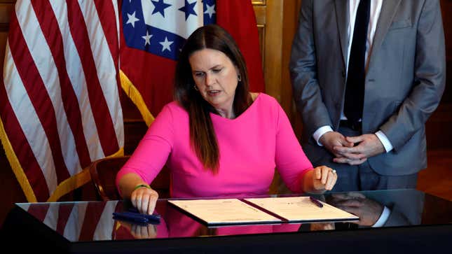 Arkansas governor Sarah Huckabee Sanders signing SB 396 into law in April. 