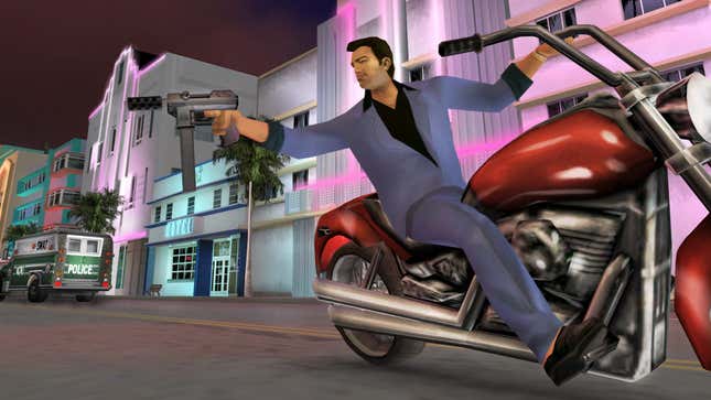 A man in a blue suit points a sub-machine gun at an off-screen target while riding a motorcycle.