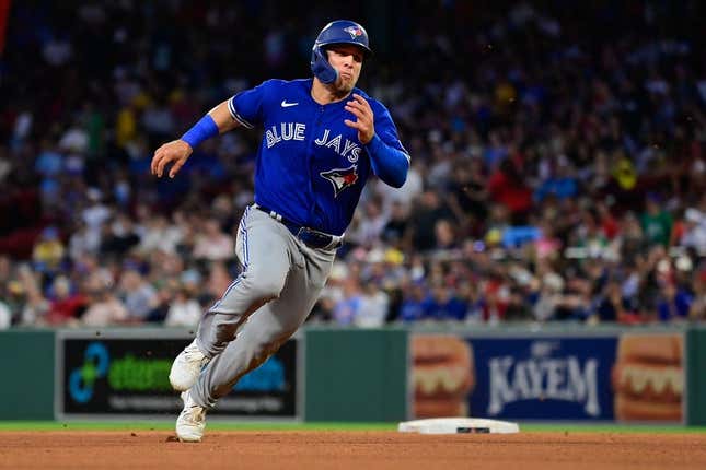Aug 4, 2023; Boston, Massachusetts, USA; Toronto Blue Jays center fielder Daulton Varsho (25) scores on an RBI by right fielder George Springer (4) during the fourth inning against the Boston Red Sox at Fenway Park.
