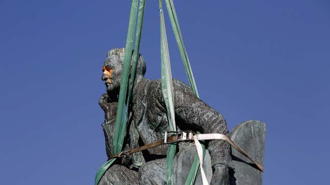 The statue of Cecil John Rhodes is bound by straps as it awaits removal from the University of Cape Town (UCT), Apr. 9, 2015