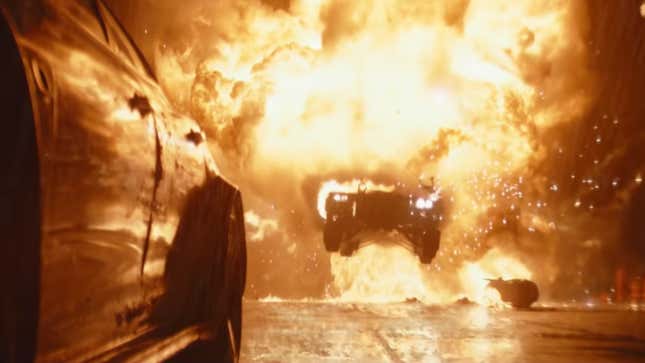 The flaming Batmobile bursts out of a giant wall of flames while in pursuit of the Penguin's car.