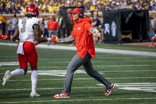 Sep 9, 2023; Ann Arbor, Michigan, USA; UNLV Rebels Defensive Coordinator/Linebackers Mike Scherer slaps hand with defensive back Johnathan Baldwin (3) after a fourth down stand against the Michigan Wolverines during the first half at Michigan Stadium.