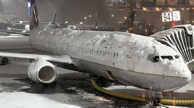 A United Airlines aircraft covered in snow at Newark Airport in January
