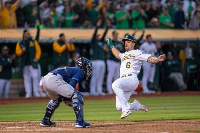 Jun 13, 2023; Oakland, California, USA; Oakland Athletics second baseman Jace Peterson (6) slides in safe against Tampa Bay Rays catcher Francisco Mejia (21) during the seventh inning at Oakland-Alameda County Coliseum.