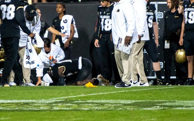 CU football&#39;s sophomore athlete Travis Hunter crumples in pain as a yellow penalty flag hits the ground following an illegal hit along the sideline by a CSU defender during the Rocky Mountain Showdown on Sept. 16, 2023 at Folsom Field in Boulder, Colo.