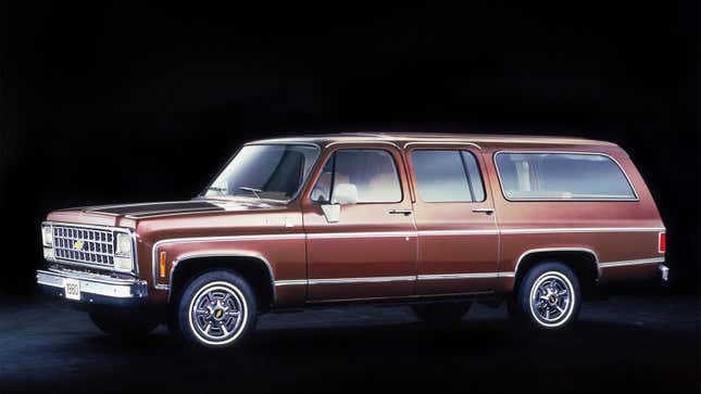A photo of a brown, vintage Chevrolet Suburban.