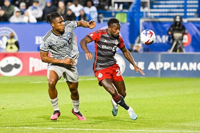 May 13, 2023; Montreal, Quebec, CAN; CF Montreal forward Chinonso Offor (9) and Toronto FC defender Richie Laryea (22) during the first half at Stade Saputo.