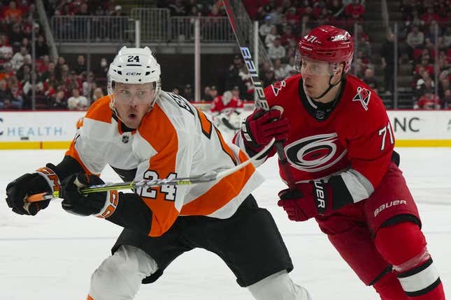 Mar 9, 2023; Raleigh, North Carolina, USA;  Carolina Hurricanes right wing Jesper Fast (71) and Philadelphia Flyers defenseman Nick Seeler (24) chase after the puck during the first period at PNC Arena.