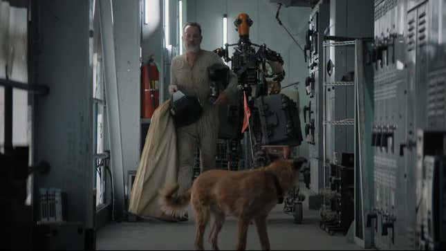 Tom Hanks, a dog, and a home-built robot walk through a high-tech bunker in a scene from Finch.